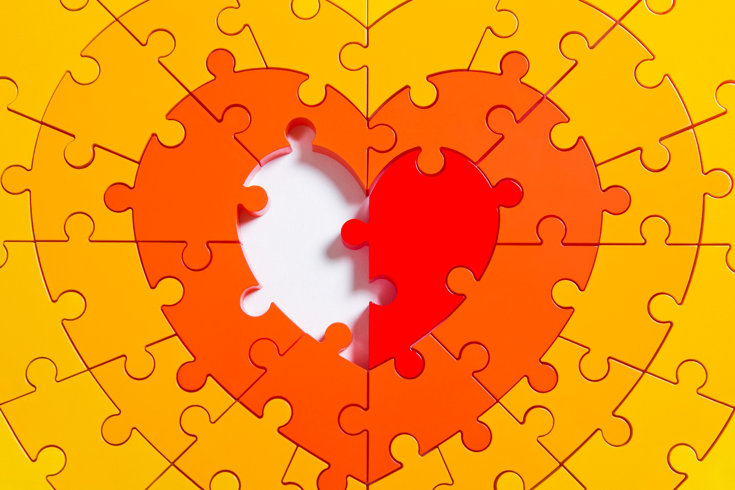 Heart-shaped puzzle missing one piece at the centre