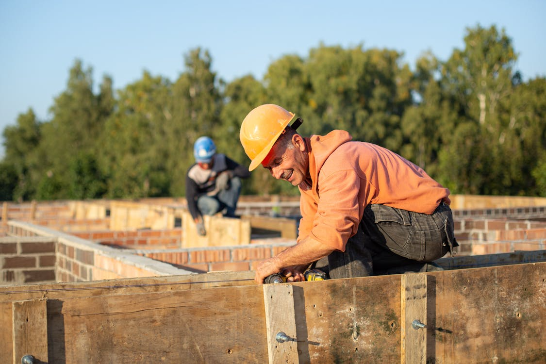 Construction workers implementing operational risk management steps on site for workplace safety and compliance.