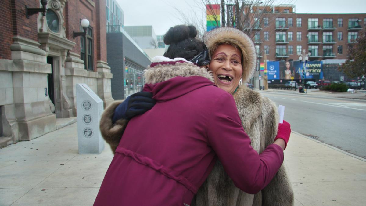  A photo of Gloria Allen blissfully hugging a woman. 