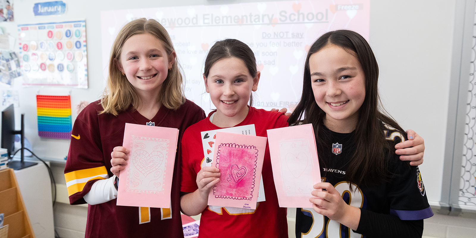 students holding handmade valentines