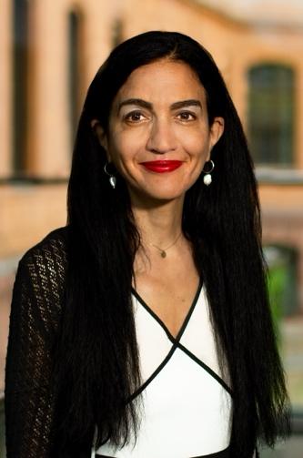 A person with long black hair and red lipstick

Description automatically generated