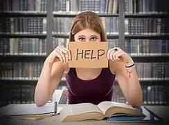 A person holding a sign in front of her face

Description automatically generated