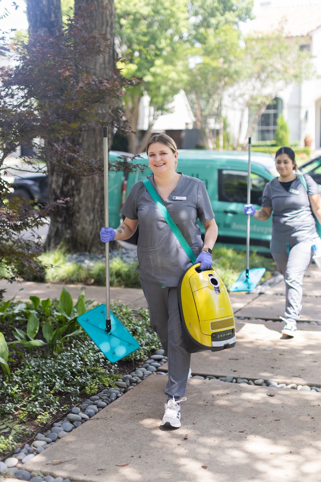 vella cleaning experts happily cleaning client's home to make it spotless