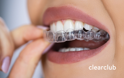 Woman trying on a clear night guard, questioning if her mouthguard is causing bad breath.