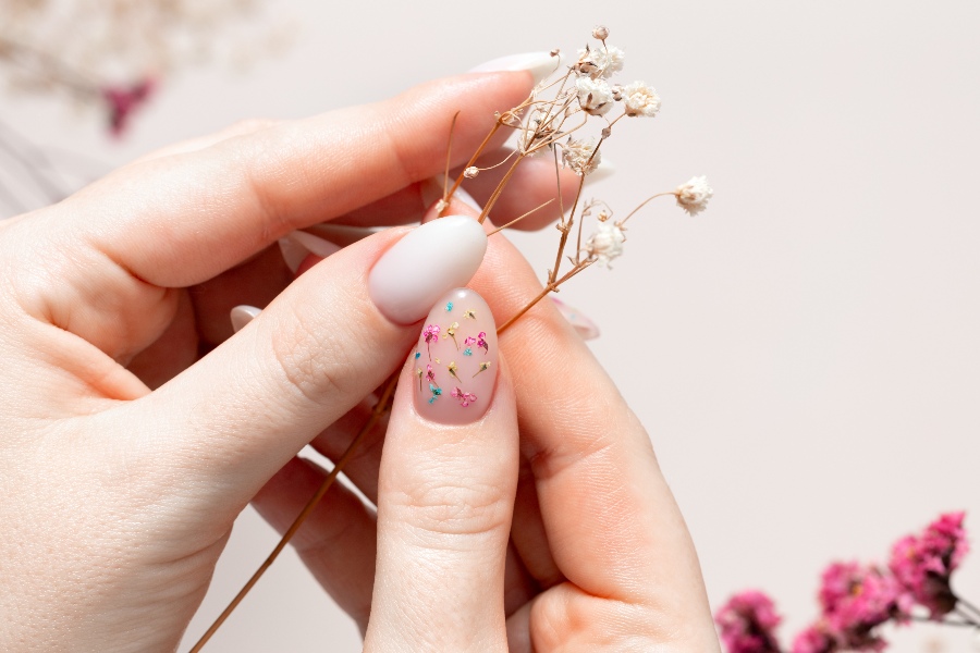 Pressed flower details bring a natural, organic twist to French nail tip design.