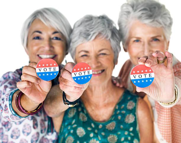 We're registered voters! Studio portrait of a group of senior women holding up election buttons against a white background seniors voting stock pictures, royalty-free photos & images