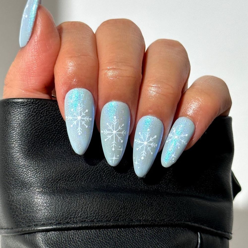 Close up of hands with blue winter nails having Simple winter nails 