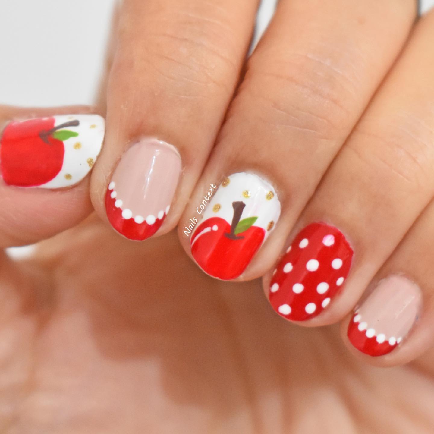 Close-up of hands with fall nail design having Apple Picking-Inspired Nails