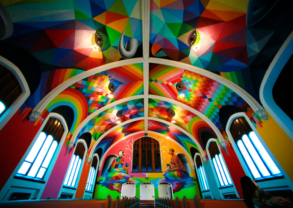 The interior of the International Church of Cannabis, the walls and ceilings of which are covered in bright, colorful murals.