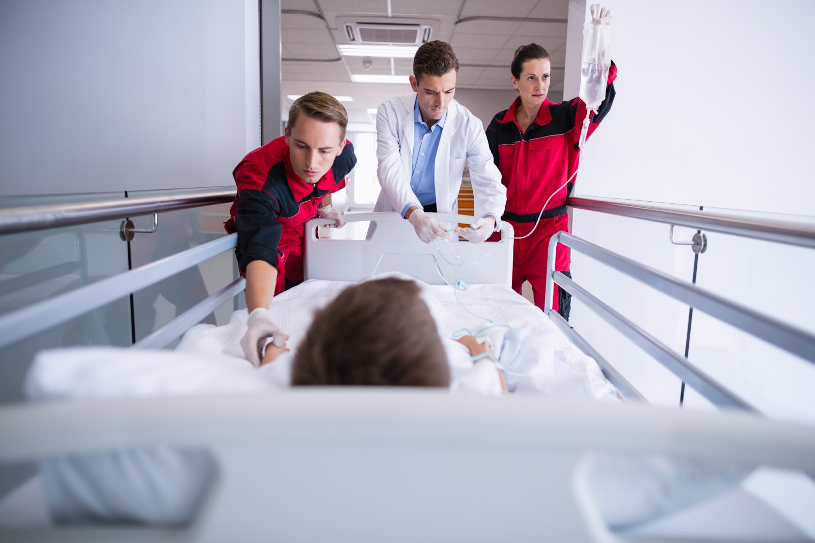 Doctors pushing emergency stretcher bed in the corridor