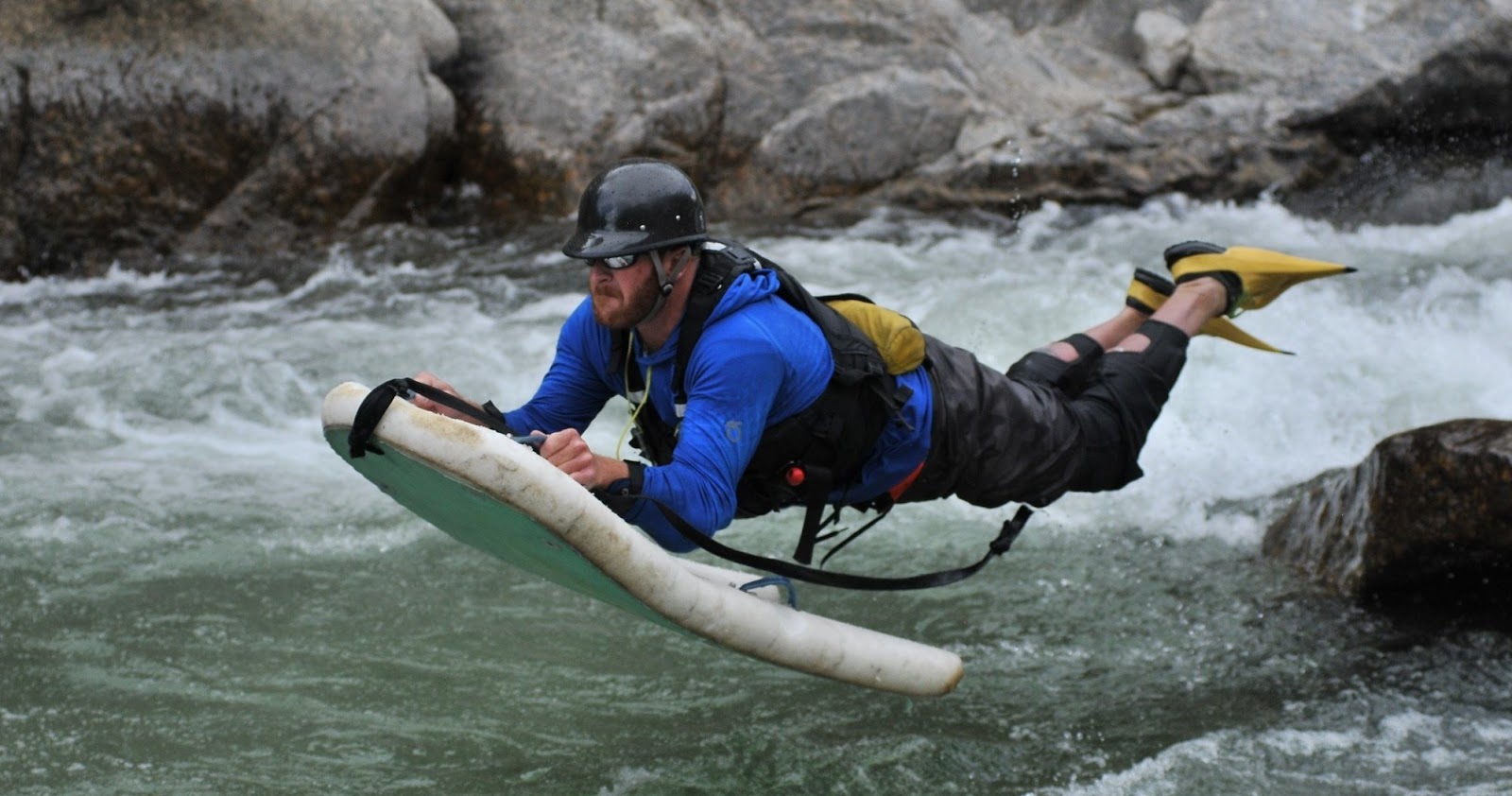 a person riding a snow board on a body of water