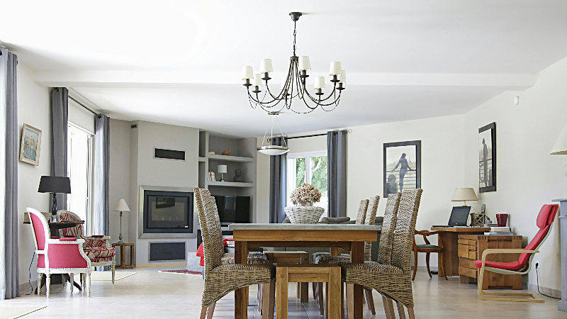 A dinner table under a chandelier 