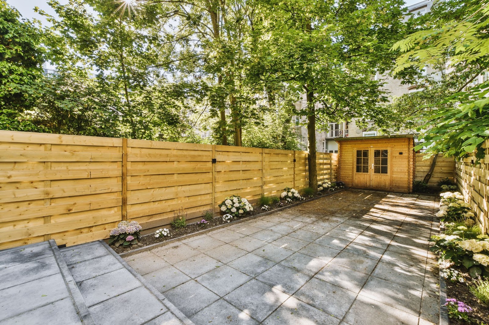 A neat wooden fence made of reclaimed pallet wood, offering a rustic touch to the outdoor space.