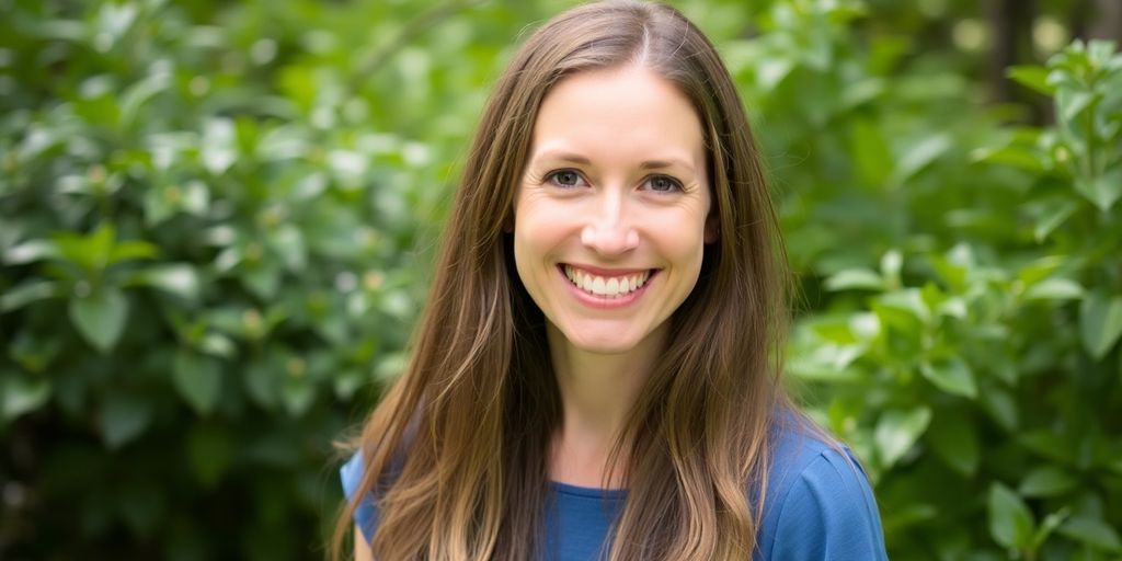 Julie O'Neill smiling in a green outdoor setting.