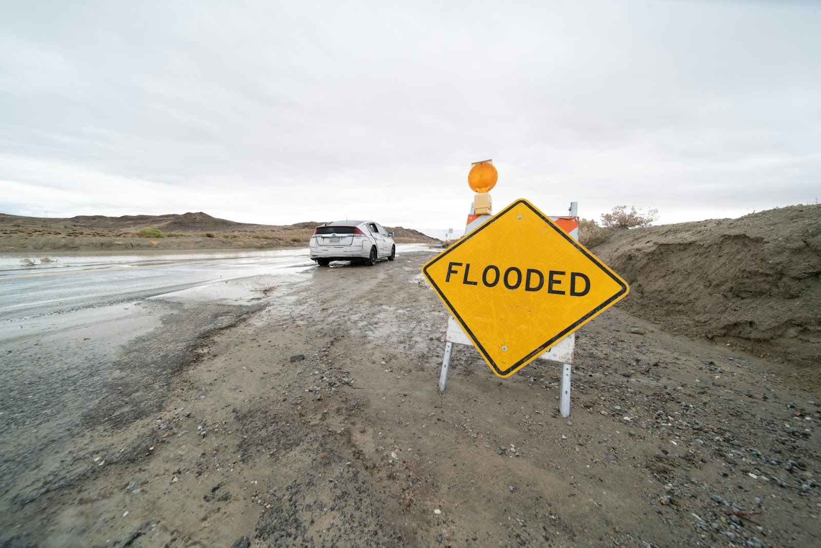 a sign "flooded" on the road