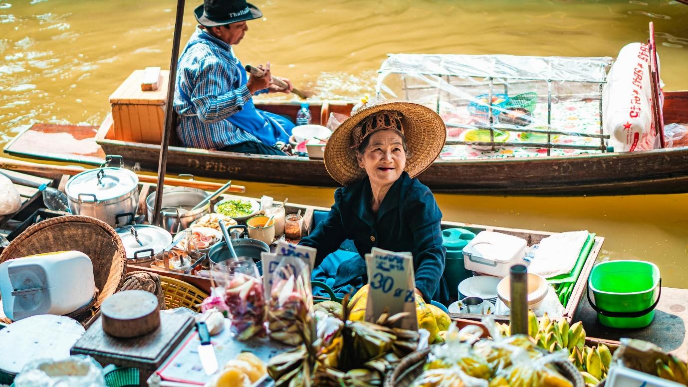 A person in a boat with food on it

Description automatically generated