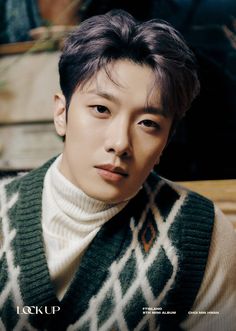 A picture of Minhwan wearing a milk colour turtle neck dress and a green and sweater with a touch of milk colour 