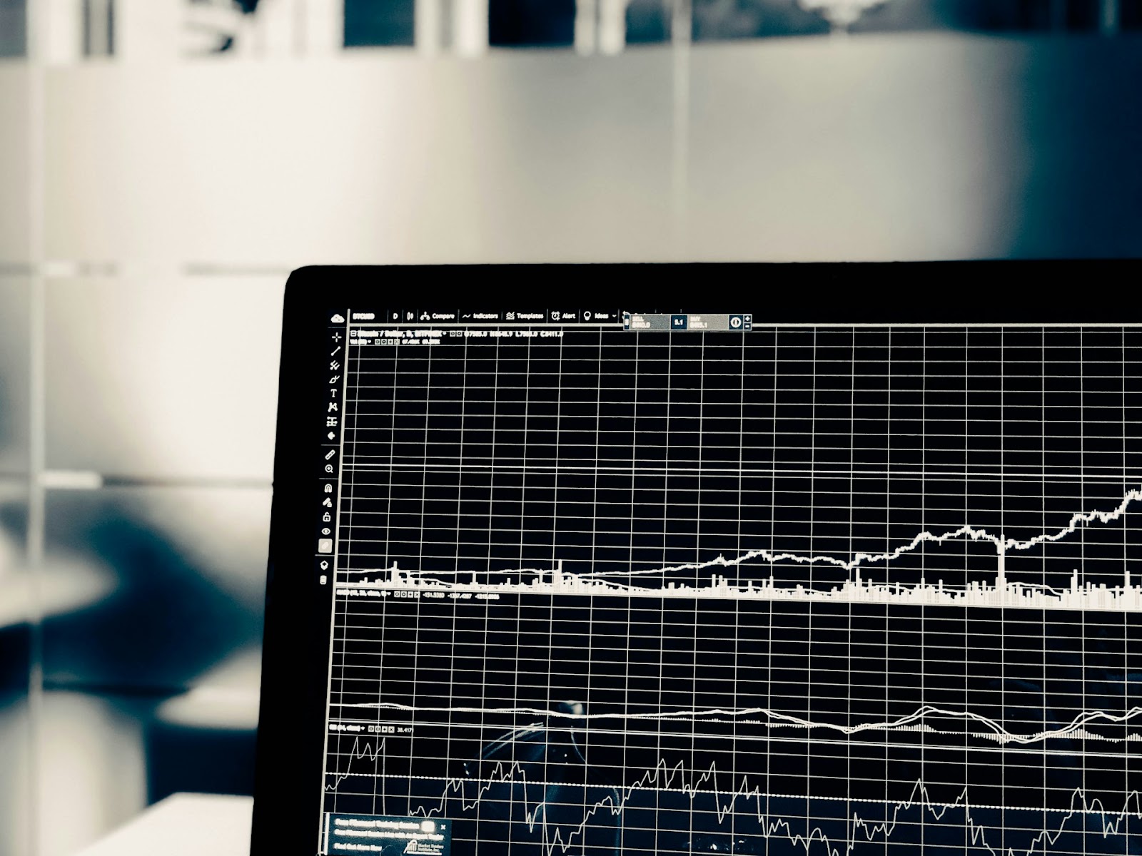 A close-up of a computer screen displaying various financial charts and graphs.