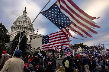 A group of people holding flags

Description automatically generated