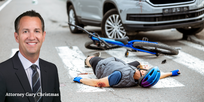 Attorney Gary Christmas in front of an accident scene, with pedestrians injured.