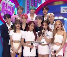 This  contain an image of BTS and BLACKPINK.  posing for a photo on stage with microphones in front of them