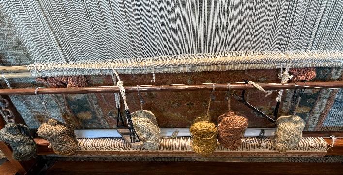 A close up of a loom

AI-generated content may be incorrect.