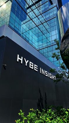 This contains a large building with the words hybe insight on it