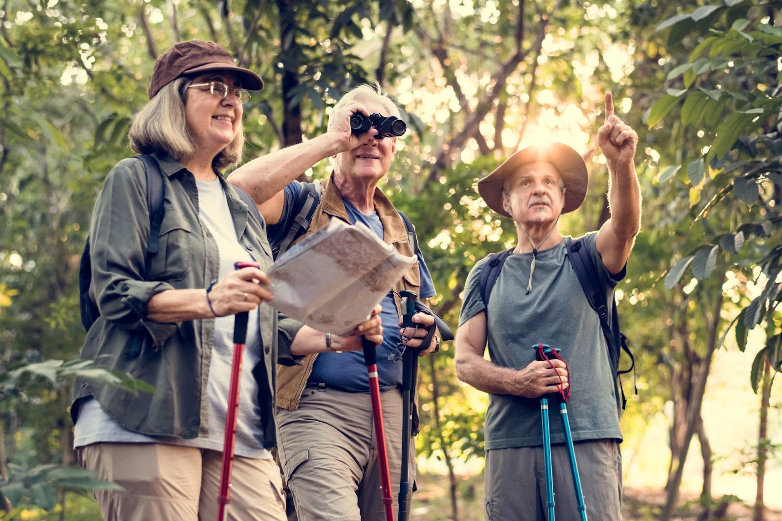 A group of happy seniors on bird-watching hike together.
