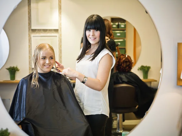 hair dresser doing clients hair