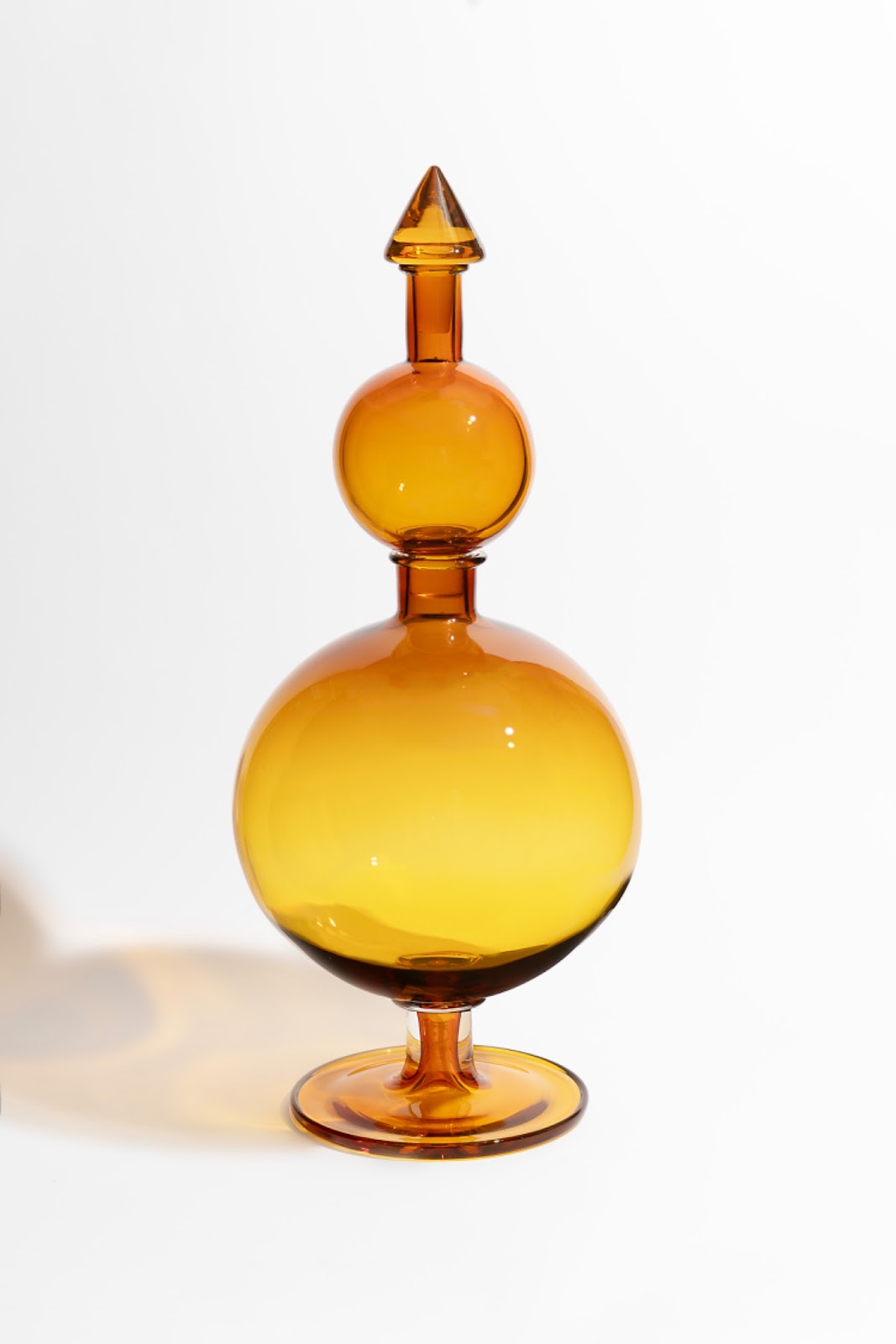 Image: "The Comet (After W.E.B. Du Bois) by Crystal Z Campbell, 2024. Hand-blown amber glass, made at the Museum of Glass, Tacoma, WA. A two-tiered oblong amber vase. Photo by Ian Lewis. Courtesy of Crystal Z Campbell.