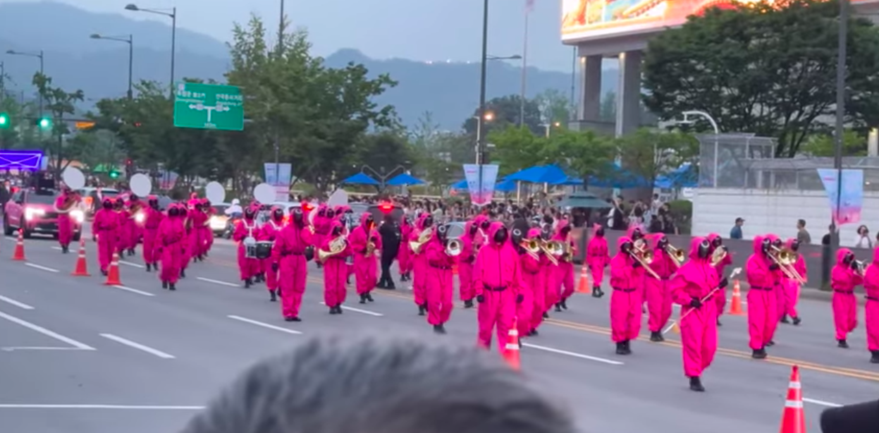 This contains an image of Squid Game Seoul parade
