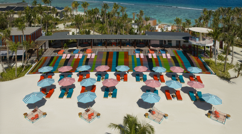 A beach with umbrellas and chairs

Description automatically generated