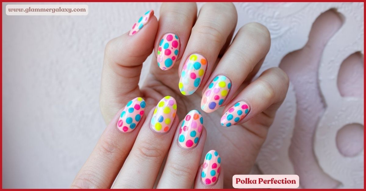 Multicolored polka dot nail art on fingers against a pale background.