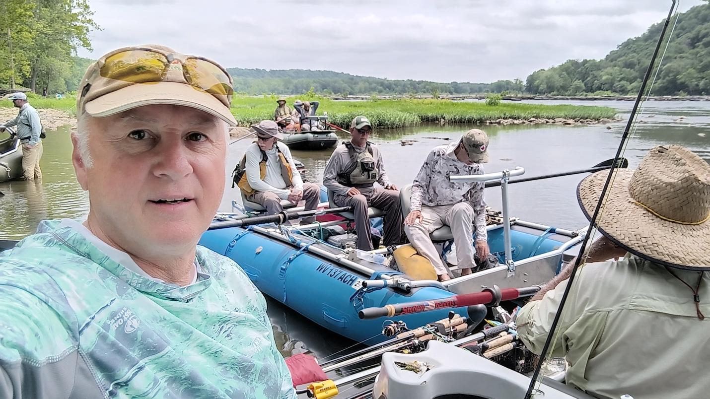 A group of men fishing on a boat

Description automatically generated