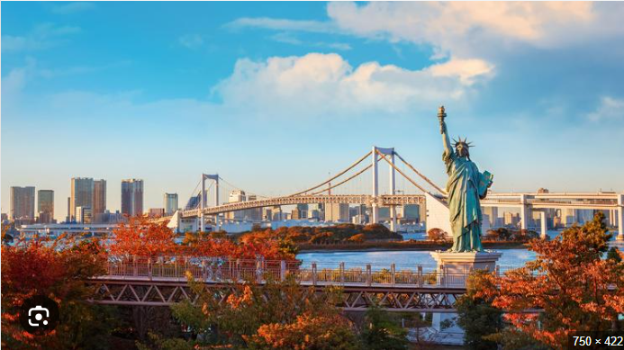 A statue of liberty with a bridge in the background
Description automatically generated