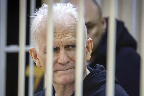 FILE – Nobel Peace Prize winner Ales Bialiatski, head of the Viasna human rights group, sits in a defendants' cage at a court session in Minsk, Belarus, on Jan. 5, 2023. (Vitaly Pivovarchyk/BelTA Pool Photo via AP, File)