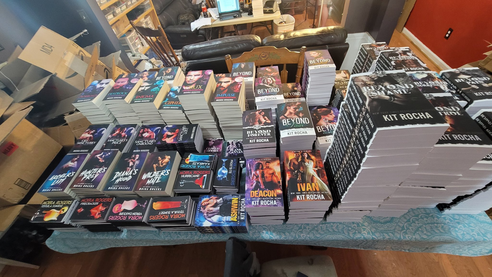 stacks of books in Kit Rocha's living room 