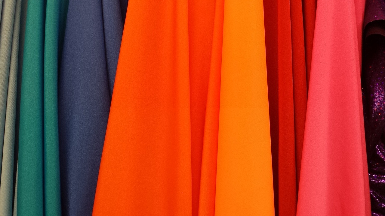 A row of various colored fabrics. 