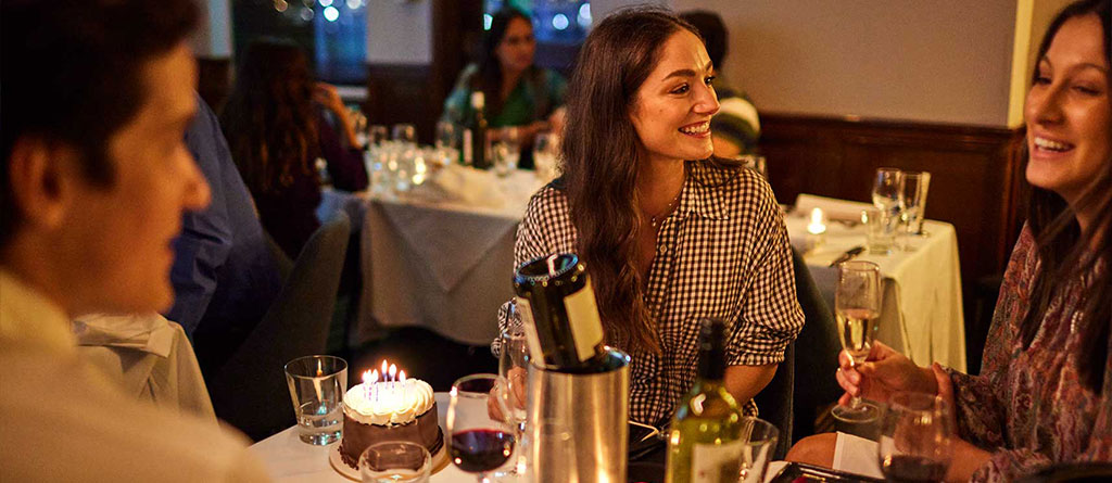 Guests enjoying birthday dinner in a birthday cruise