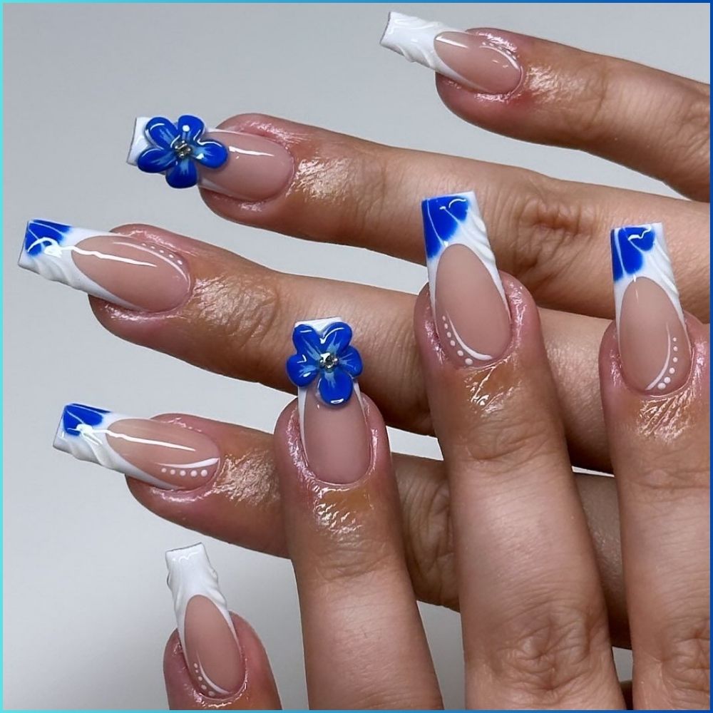 Close up of hands with flowered designed blue nails having 3D Nail Art