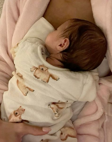 This contains an image of a baby wrapped in a blanket is sleeping