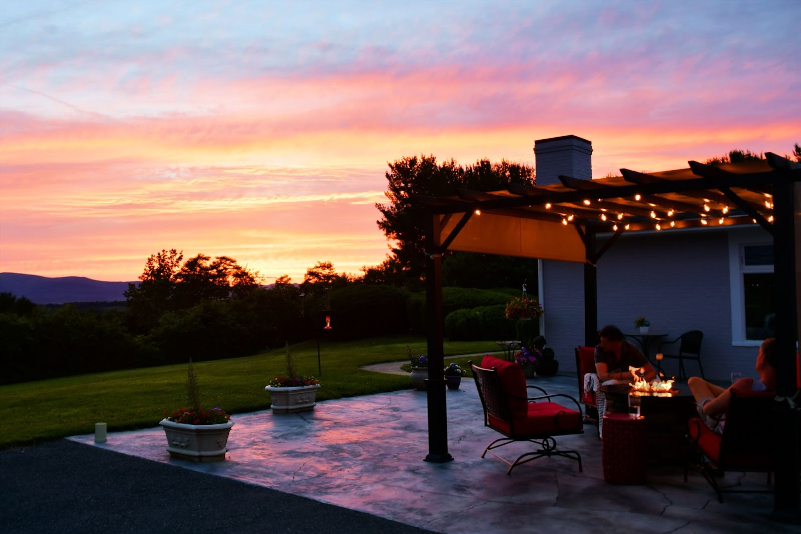 A sunset illuminating a concrete patio.