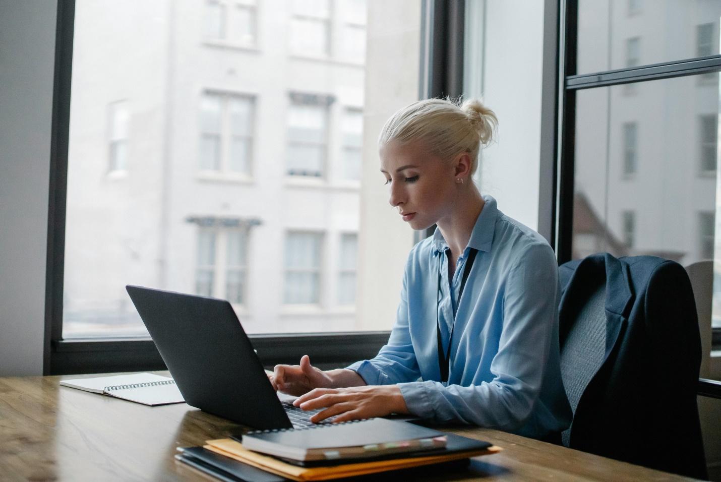 Woman sitting and using a laptop 