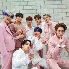 A picture of PENTAGON members on pink outfits 