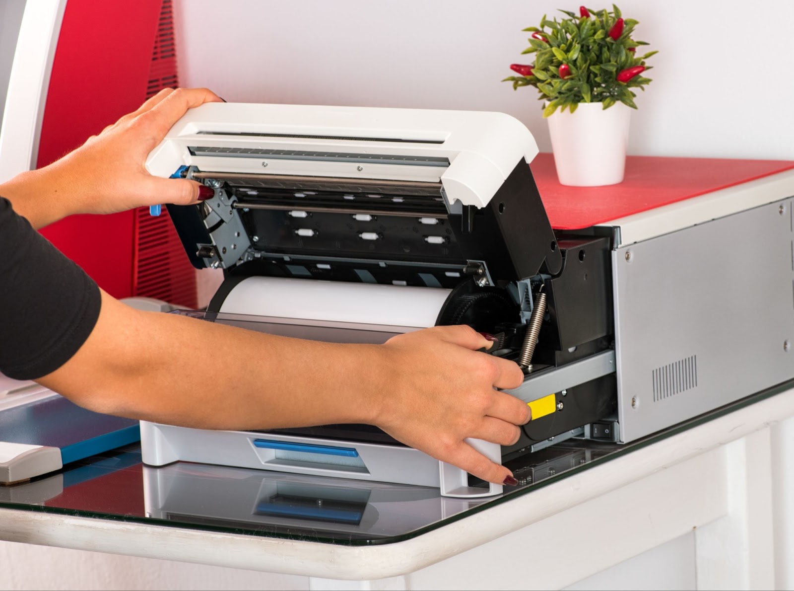Technician opening sublimation printer for maintenance and ink inspection