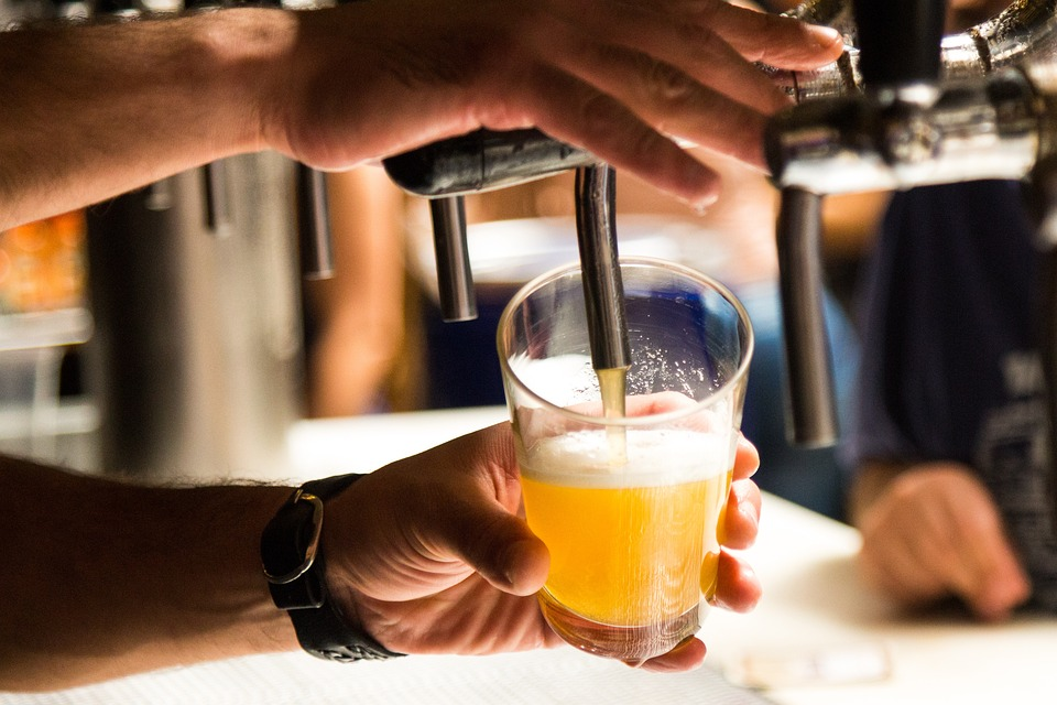 A row of draft seasonal brews glasses filled with golden ales, showcasing breweries in Cincinnati.