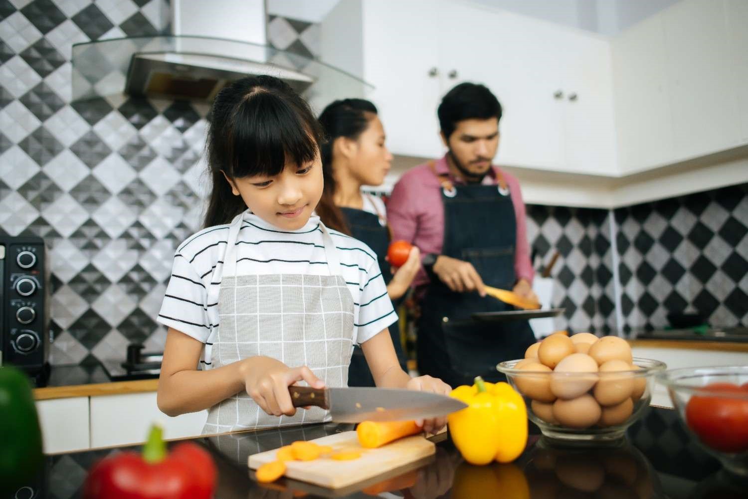 Real family moment in Elegante Interiors modular kitchen, Bengaluru - showcasing daily functionality and warmth