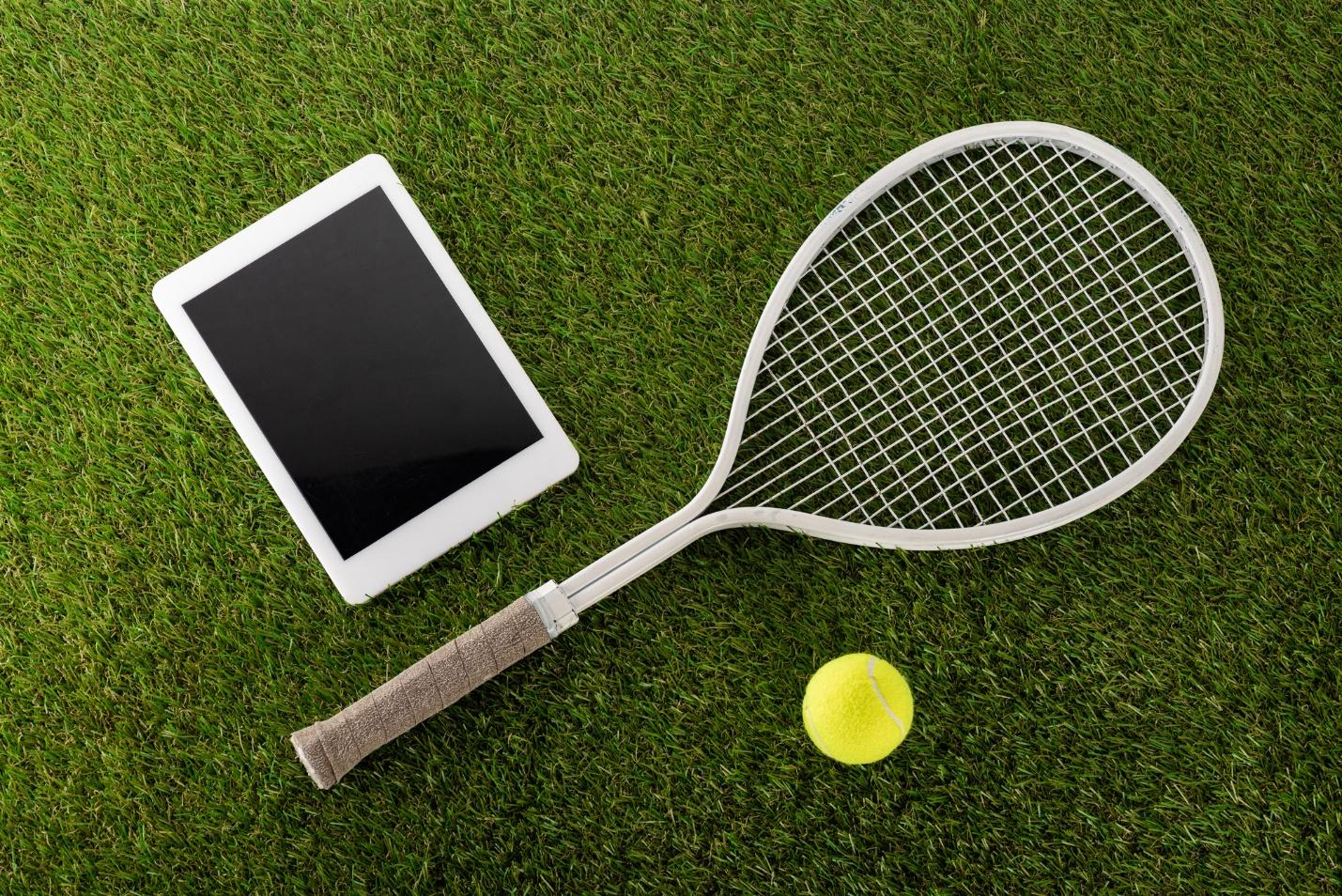 A tennis racket and a ball on grass

AI-generated content may be incorrect.