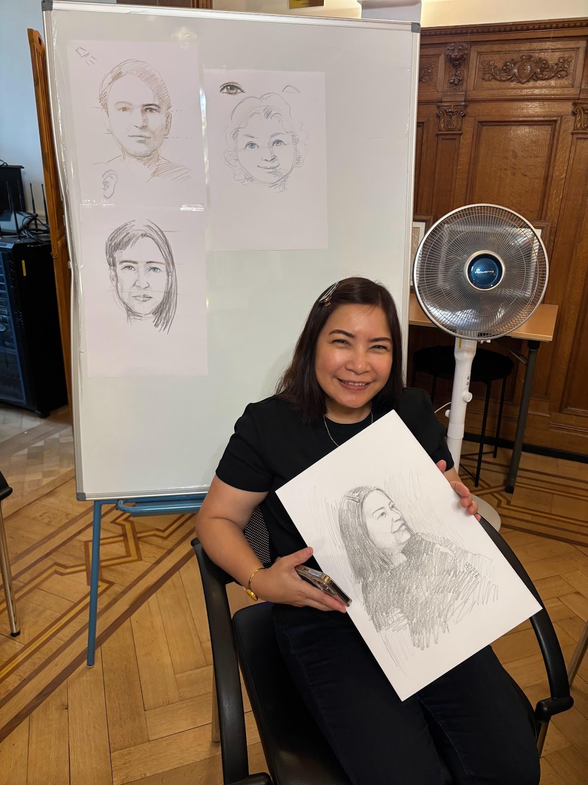 A person holding a drawingAI-generated content may be incorrect.