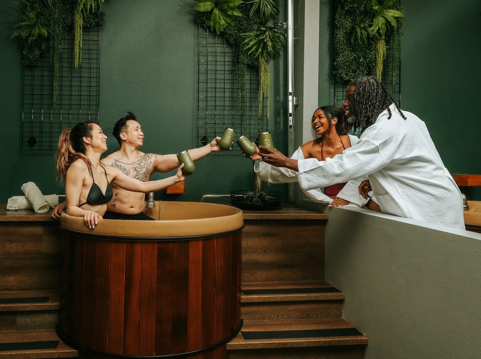 Four people enjoying beer bath at Oakwell Beer Spa